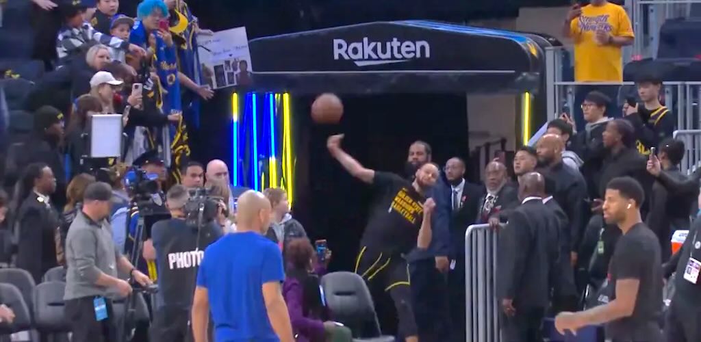 Golden State Warriors Players Tunnel Stephen Curry launches successful full court shot